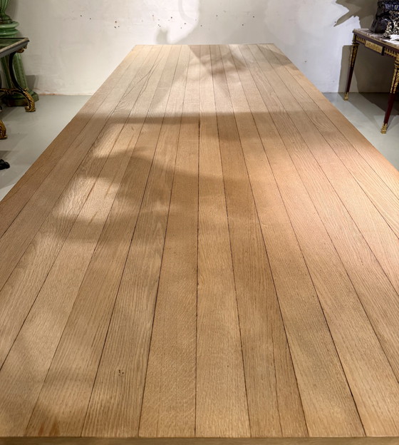 Image 1 of A large oak dining table, designed by Claire Bataille and Paul Ibens