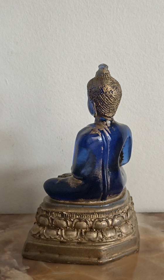 Image 1 of Old Buddha made of blue glass and stone material.