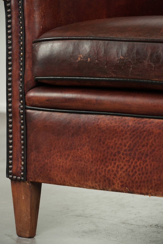 Stoere vintage schapenleren clubfauteuil met mooie kleuren en een luxe afwerking met siernagels en zwarte (photo 11 of 12)
