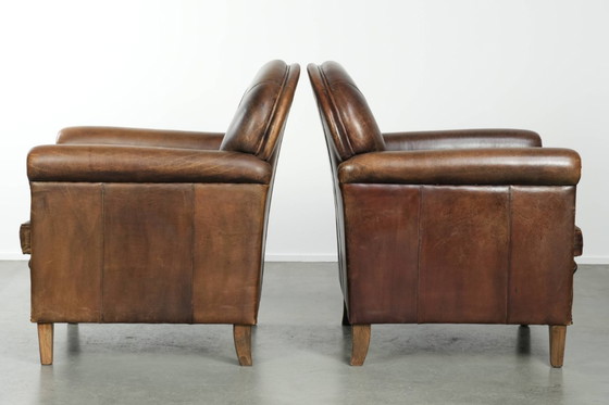 Image 1 of 2 fauteuils design en peau de mouton avec une belle patine