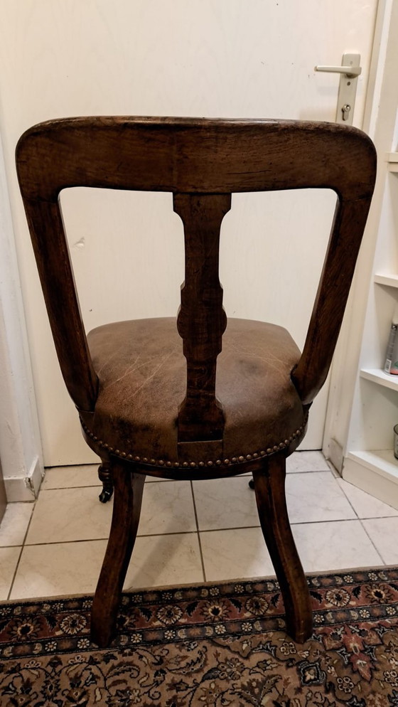 Image 1 of 4 antique wooden chairs with leather upholstery and decorative nails