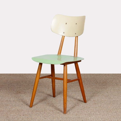Green chair produced by Ton in the 1960s