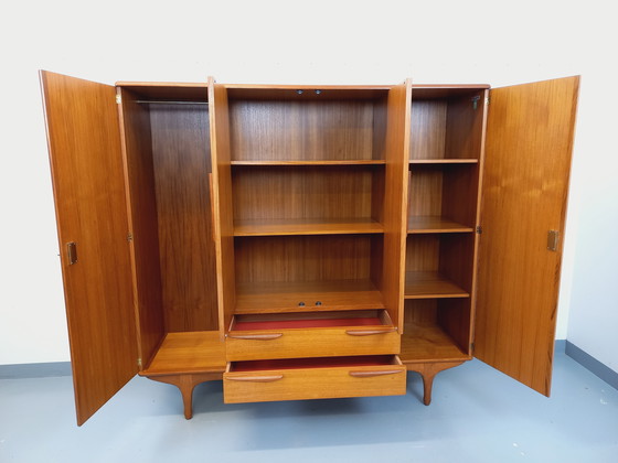 Image 1 of Scandinavische vintage kledingkast in teakhout uit de jaren 60 van ontwerpers Tricoire en Vecchione voor "Meubles TV Paris".