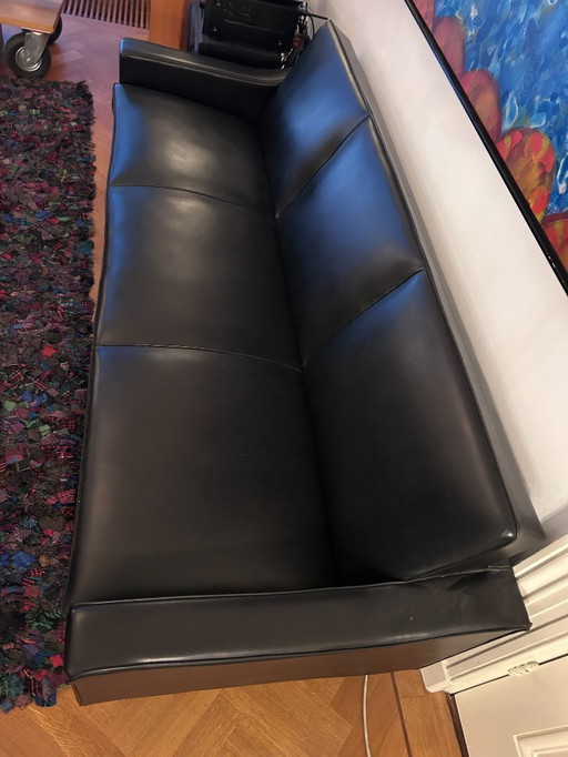 modern three-seater sofa in black imitation leather/leather look