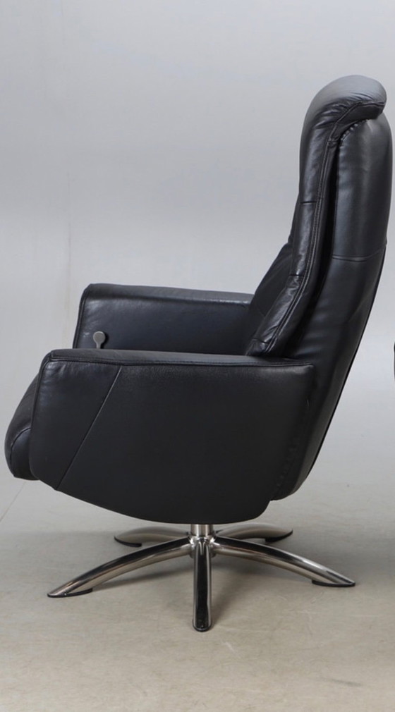 Image 1 of Modernist black leather armchair with a chrome X-frame base in a contemporary style, in good condition with minor signs of aging