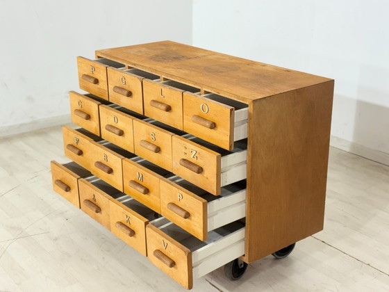 Image 1 of Beautiful vintage apothecary cabinet / compartment cabinet on casters – 16 compartments