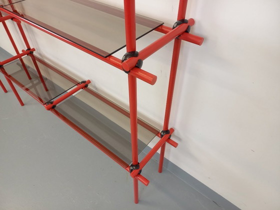 Image 1 of Vintage Italiaanse Bauhaus-boekenkast van rood metaal en rookglas uit de jaren 70.