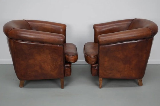 Image 1 of Vintage Nederlandse leren clubfauteuils in cognackleur, set van 2 met voetenbank