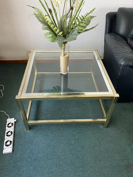 Couchtisch aus Glas mit goldenen Details
