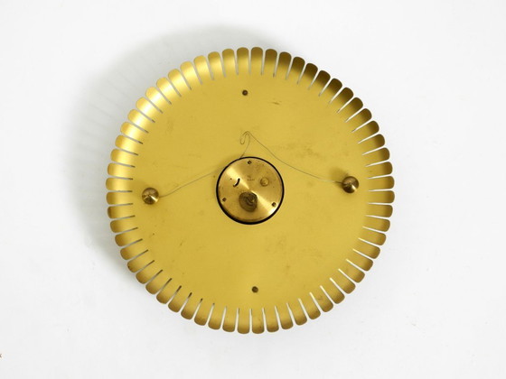 Image 1 of Beautiful original Mid Century Sunburst Atlanta Universe wall clock made of heavy brass with a mechanical seven-day movement
