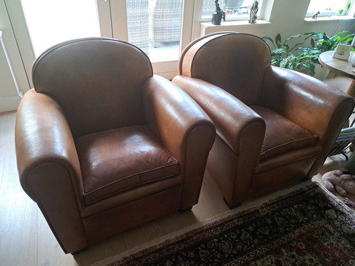2 cognac colored leather armchairs by Artistic