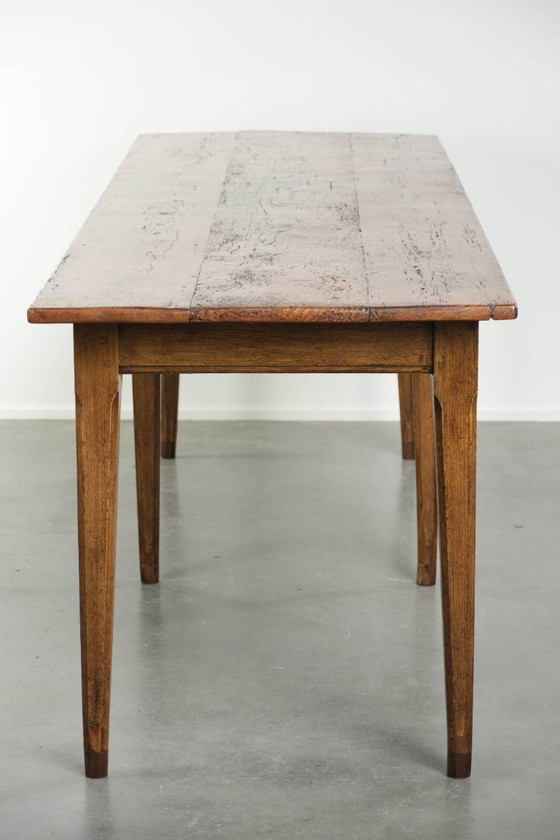Image 1 of Large, relatively narrow antique French farmhouse dining table made of pine from the early 19th century with a beautiful patina.
