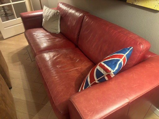 Red leather two-seater sofa