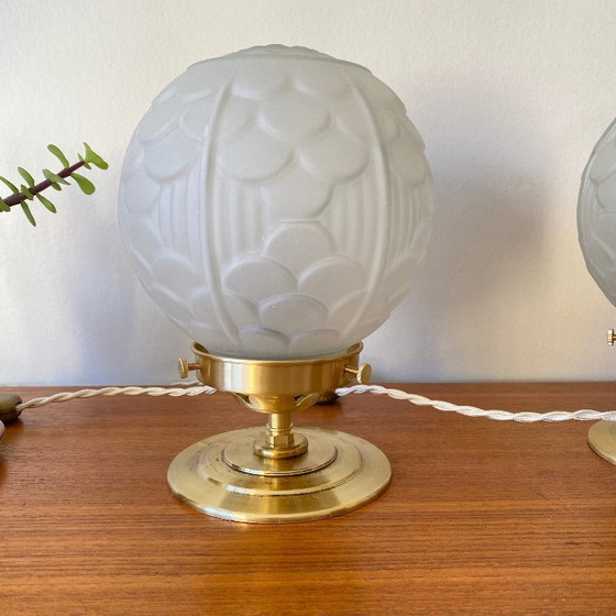 Image 1 of Pair of vintage bedside lamps with antique glass globes and brass bases, circa 1950