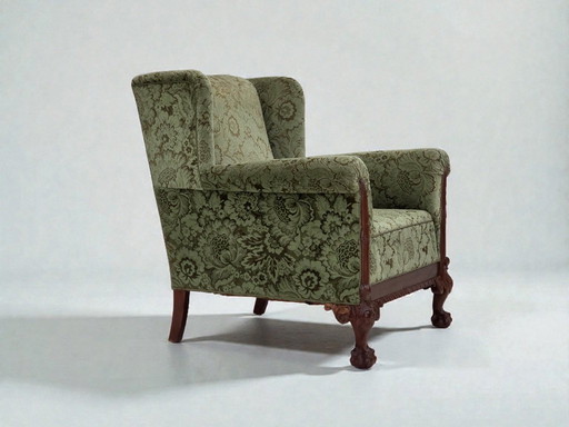 Dänischer Relaxsessel aus den 1950er Jahren, grüner Möbelveloursbezug, geschnitztes Eichenholz.