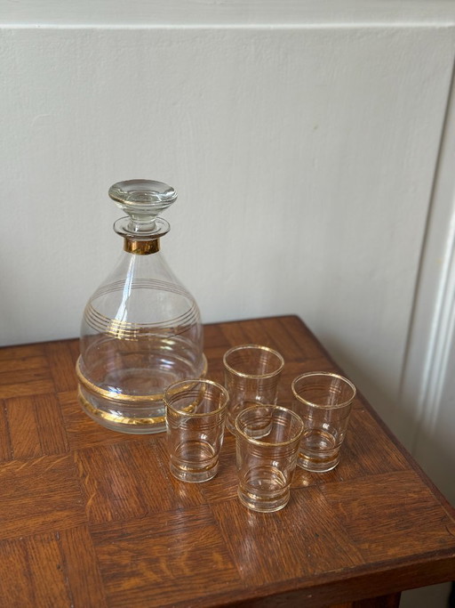 Art Deco style decanter and 8 gold-rimmed liqueur glasses