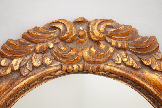 Image 1 of Oval mirror, gilded and carved from wood. Exclusive vintage mirror, handmade by expert artisans.