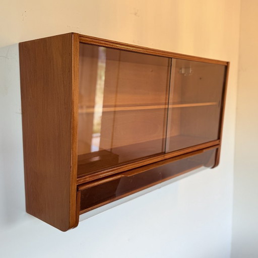 Hanging display case with flap at the bottom