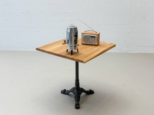 Bistro table made of acacia wood with a cast iron base in country style