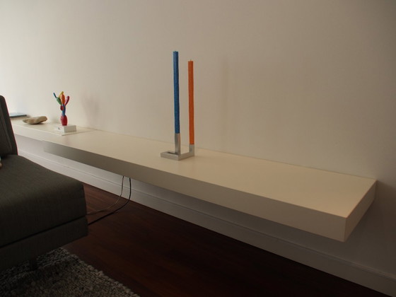 Image 1 of Armadio a ribalta di design con due mensole a muro adiacenti .