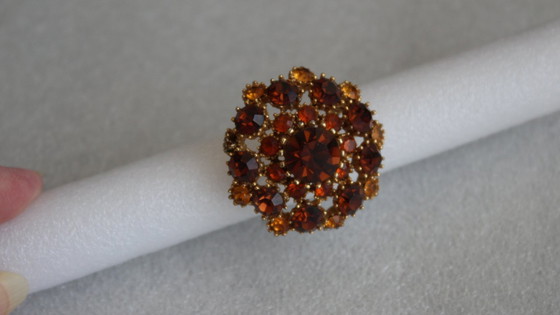 Image 1 of Vintage costume jewelry brooch with amber rhinestones, marked SPHINX