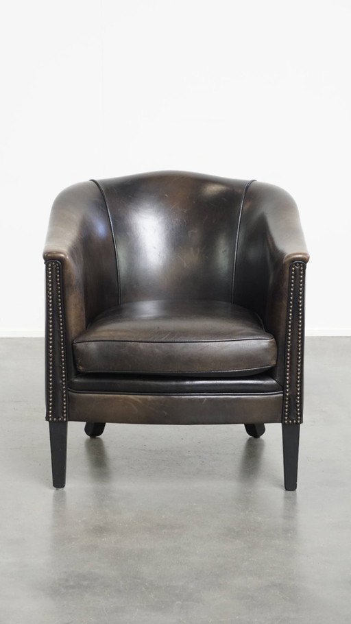 Black/gray club chair made of sheep leather