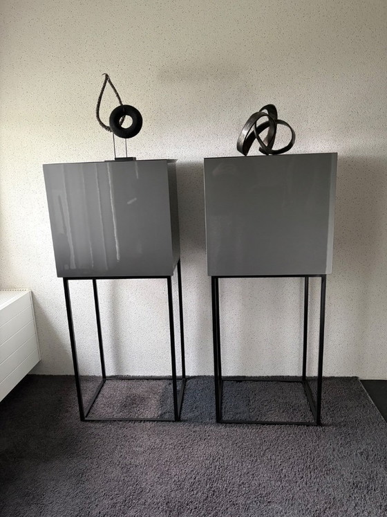 Image 1 of 2 grey cabinets on a steel frame