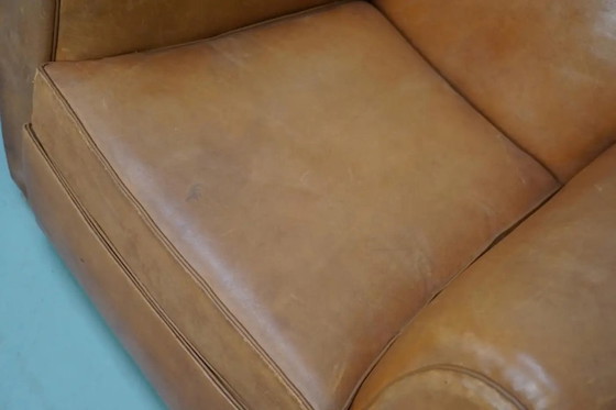 Image 1 of Ein Paar französischer cognacfarbener Ledersessel mit schnurrbartförmigen Rückenlehnen, 1950er Jahre