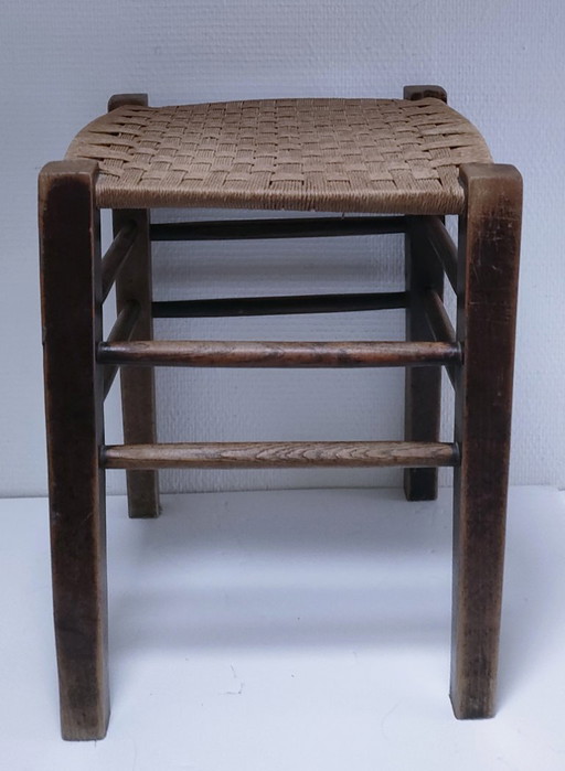Vintage wooden stool with plant braiding
