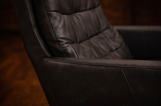 Image 1 of Modernist black leather armchair with a chrome X-frame base in a contemporary style, in good condition with minor signs of aging