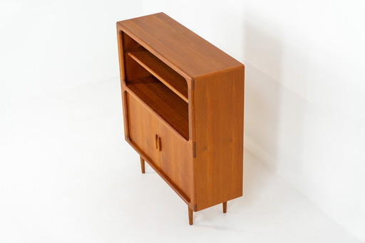 Bookcase in teak by Svend Dyrlund with tambour doors (Denmark, 1960s).
