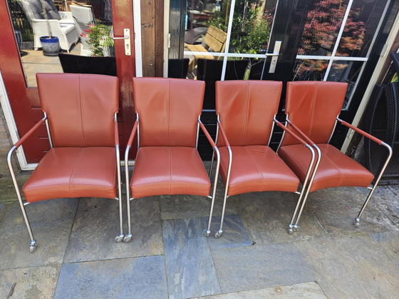 Image 1 of 4 red leather dining chairs on wheels, brand Bert Plantagie