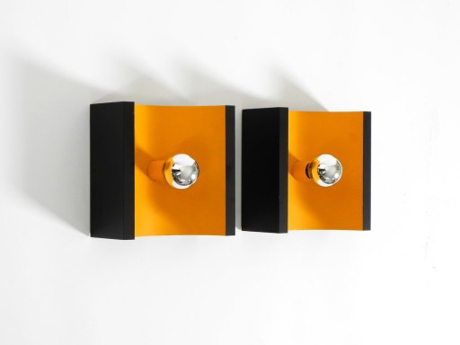 A rare pair of original 1960s Space Age metal wall lamps by Klaus Hempel for Kaiser Leuchten in yellow and black