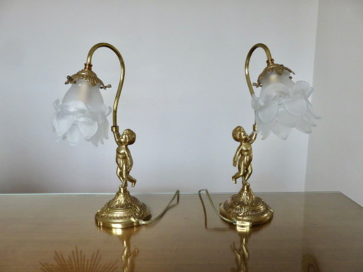 pair of art nouveau "cherubs" bronze and frosted glass lamps