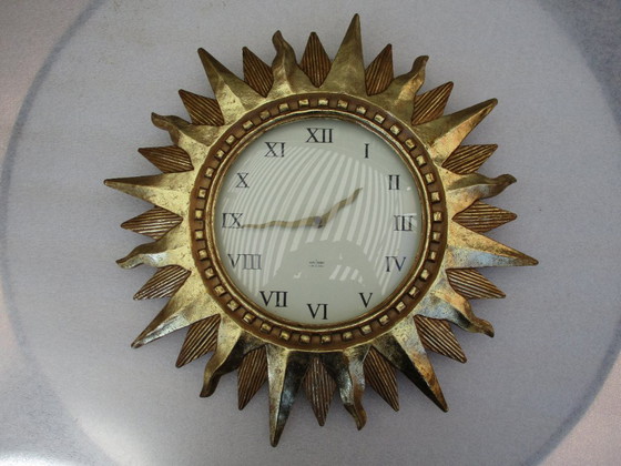 Image 1 of Karlsson Zonneklok vergulde 22k goud zware wandklok uit eind 20e eeuw werkt prima.