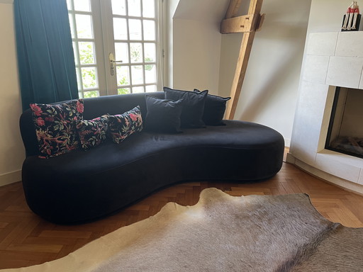 Black velour curved sofa
