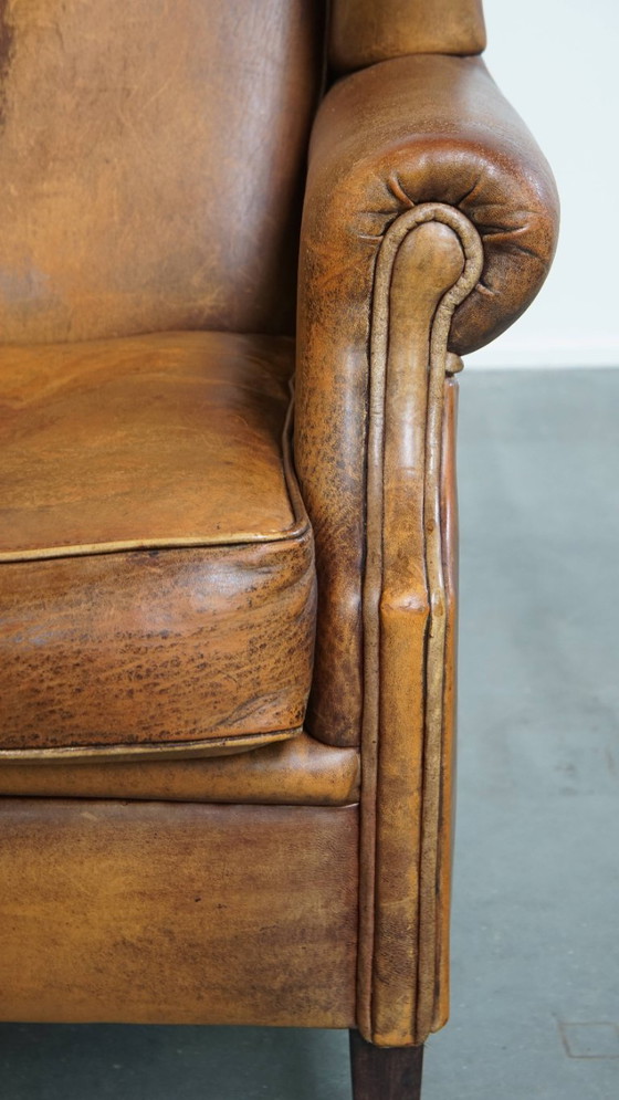 Image 1 of Karaktervolle vintage schapenleren oorfauteuil met een mooi patina