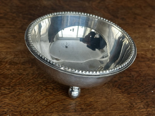 Silver metal tripod cup with pearl outline in the Jean Desprez style