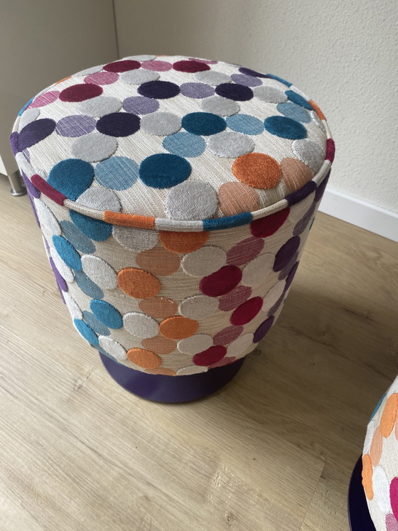 Conjunto único de muebles reciclados: dos pufs con diseño de McDonald's retapizados sobre bases de acero. (photo 3 of 11)