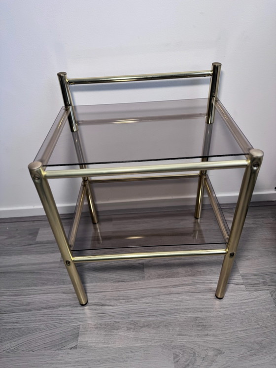 Vintage Regency stule  two-tier side table or nightstand featuring a brass-finished metal frame and smoked (photo 3 of 14)