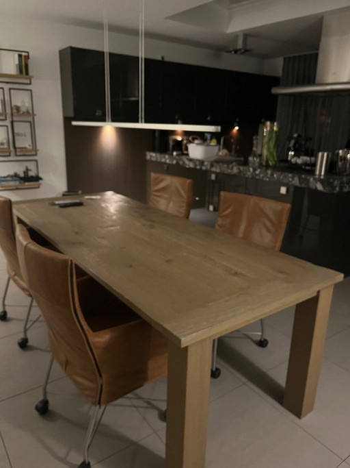 Solid oak table, dimensions 225cm long and 95cm wide, with a protective coating on the top. Ideal for a family.