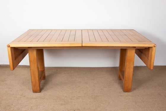 Image 1 of Gran mesa de comedor extensible de roble macizo, diseñada por Guillermo y Chambron en 1960.