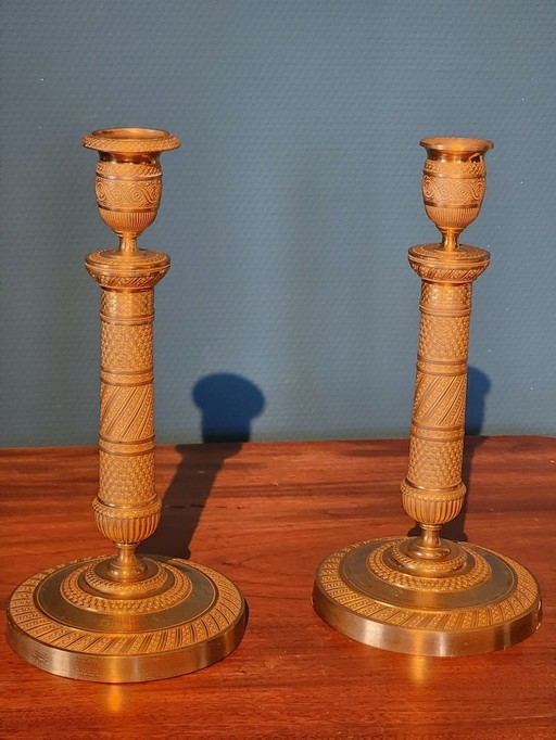 2 Bronze gilded Empire candlesticks.