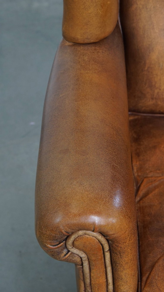Image 1 of Karaktervolle vintage schapenleren oorfauteuil met een mooi patina