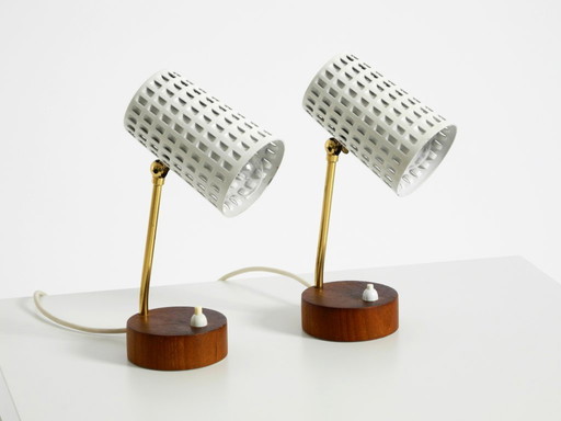 A pair of beautiful mid-century modern bedside lamps with perforated metal shades and teak wood bases