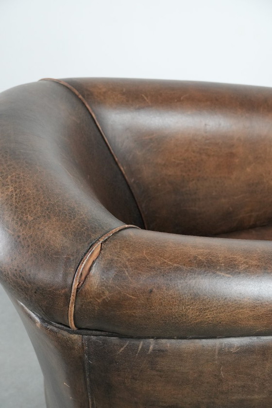 Image 1 of Sturdy and characterful vintage sheepskin club armchair