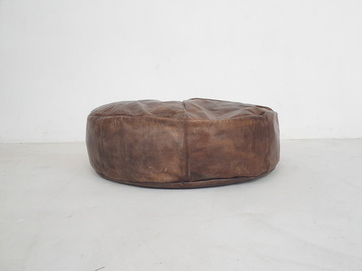 Dark brown leather ottoman. In good vintage condition