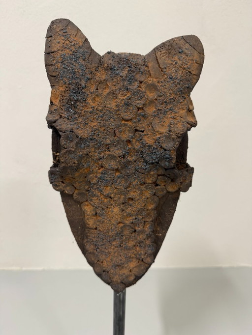 Decorative clay horse head on steel base