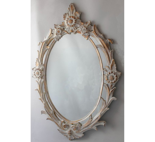 Antique oval mirror carved in wood.