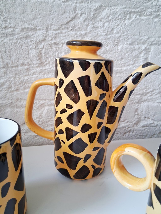 Ceramic coffee pot with 2 mugs in giraffe print, also nice for chocolate milk.